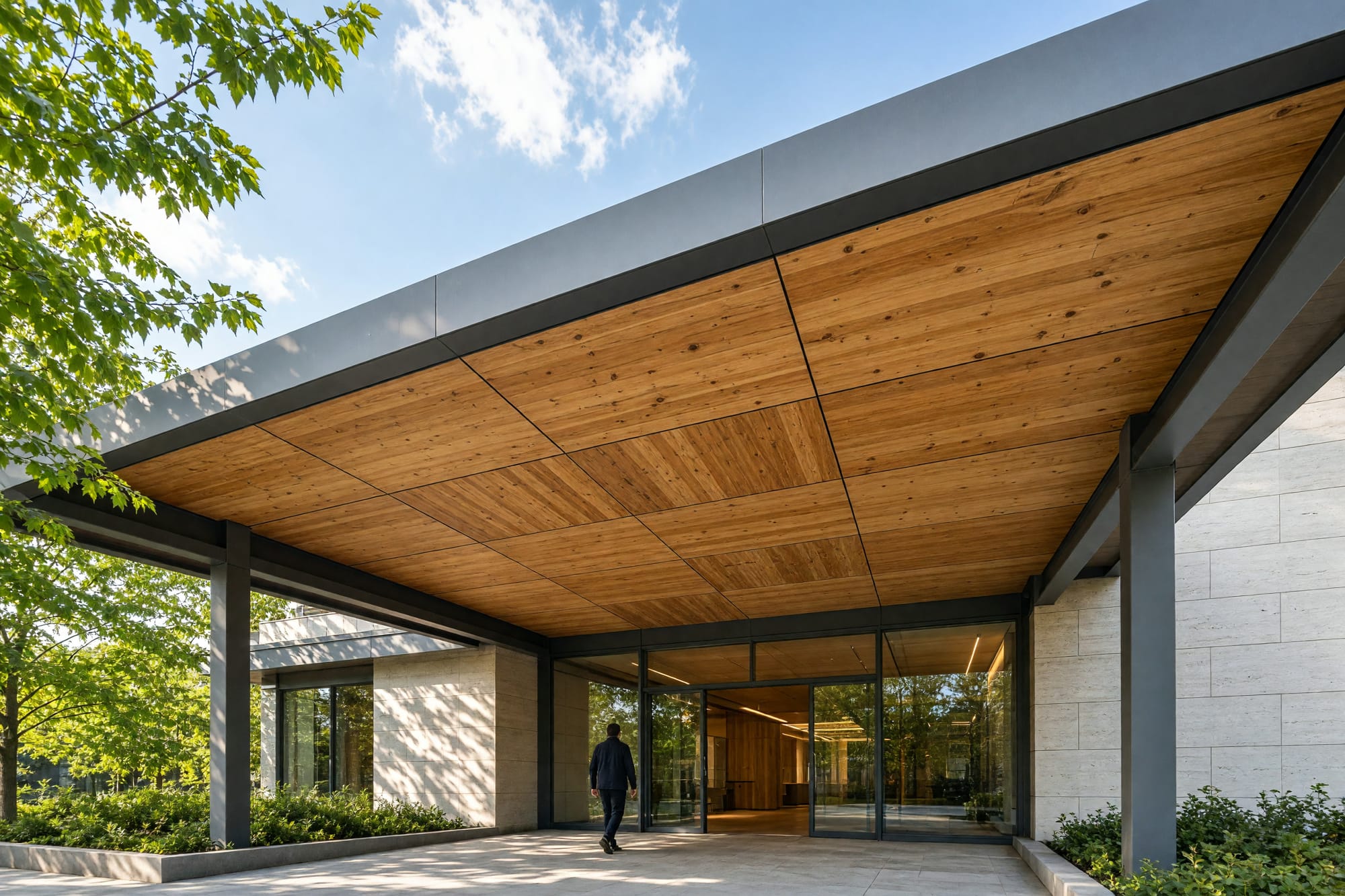 The entrance canopy of a timber office building seen from below against the sky