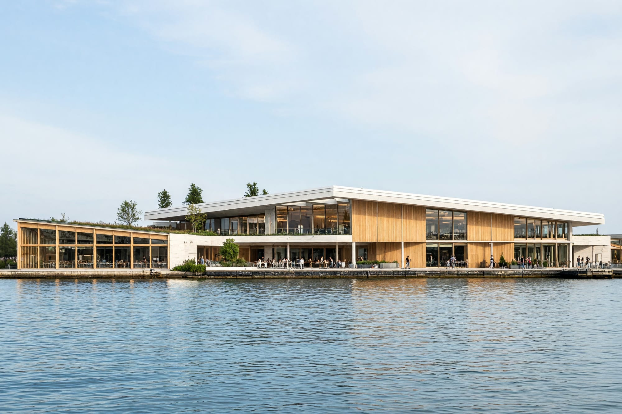 The terminal seen from the water on a bright day reading as one calm horizontal