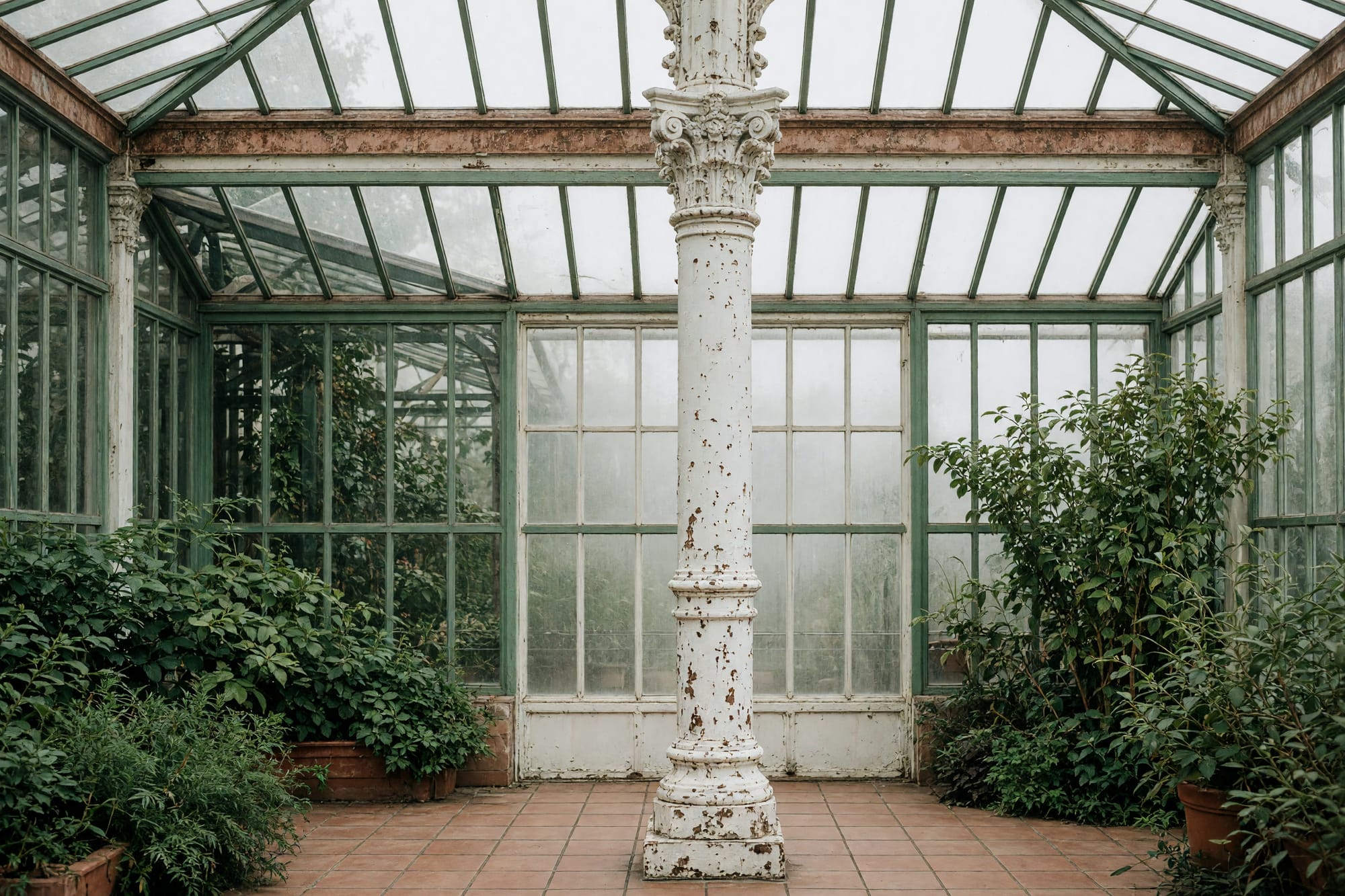 A cast iron column and capital carrying the roof, paint layers legible at hand scale